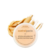 Aveda Control Paste vista frontal con tapa mostrando el envase y beneficio de textura