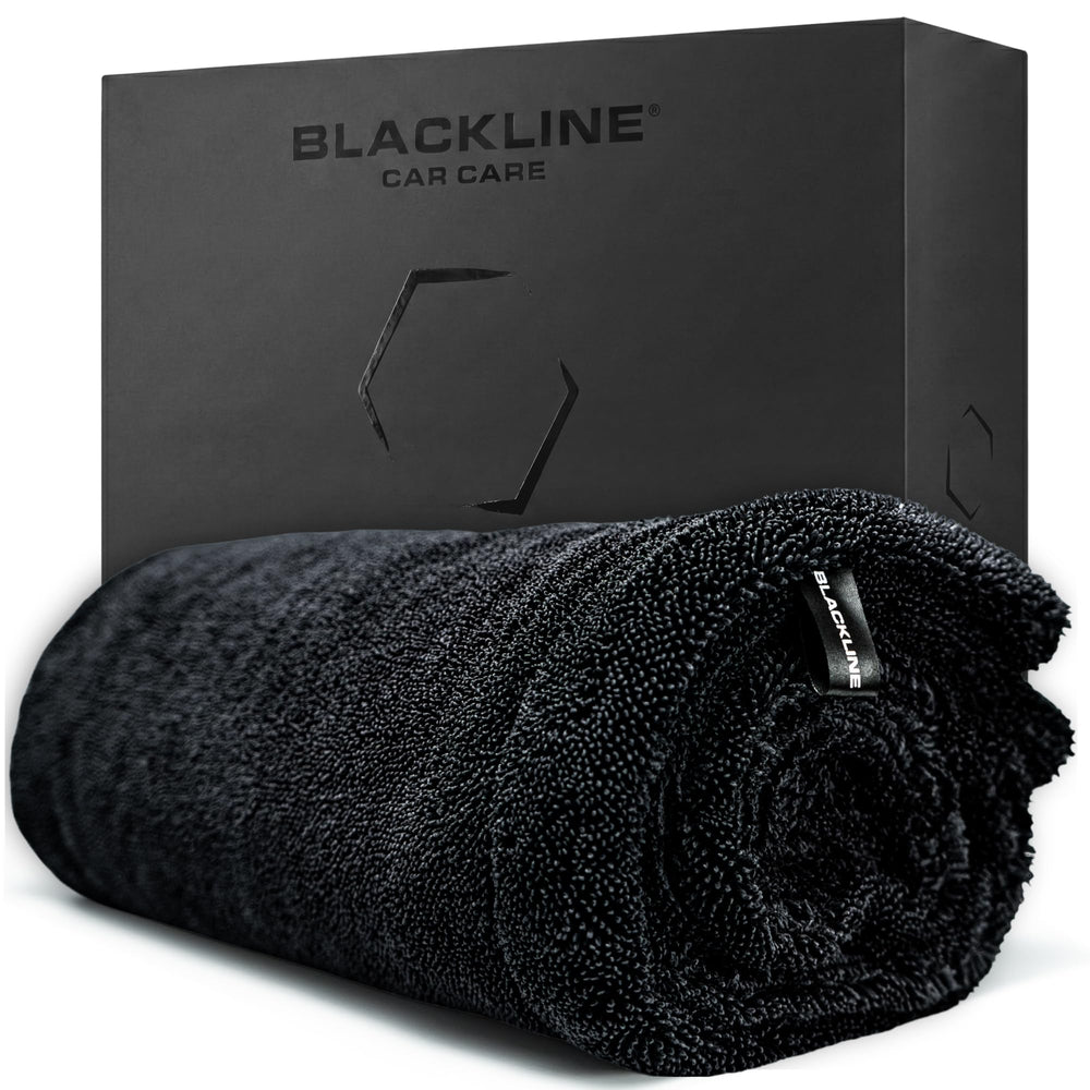Blackline front view of towel packaging showing product and benefits