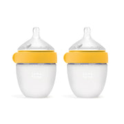 Comotomo botella frontal amarilla mostrando diseño y doble pack beneficios