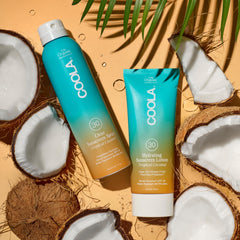 Applying COOLA sunscreen in hand to show smooth, non-greasy protection
