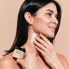 Eight Saints applying cream to neck demonstrating easy daylight absorption
