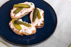 Maille cornichons sobre tabla de quesos realzando combinación de sabores