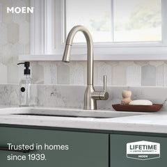 Moen Adler high-arc spout beside a pot illustrating added clearance and fill capacity