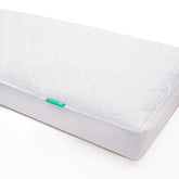 Newton Baby front view of waterproof crib pad showing protective fit and easy care