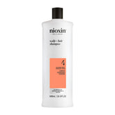 NIOXIN System 4 vista frontal del envase mostrando el diseño profesional y beneficios