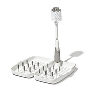 OXO Tot front view of compact travel drying rack showing organized bottles and pegs