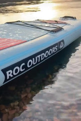 Roc inflated SUP on a calm lake illustrating stability and family use