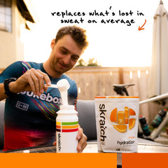 Skratch Labs scoop with orange powder illustrating easy portioning and fast mixing