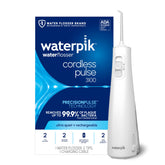 Waterpik front view showing sleek white flosser and included tips for portable cleaning
