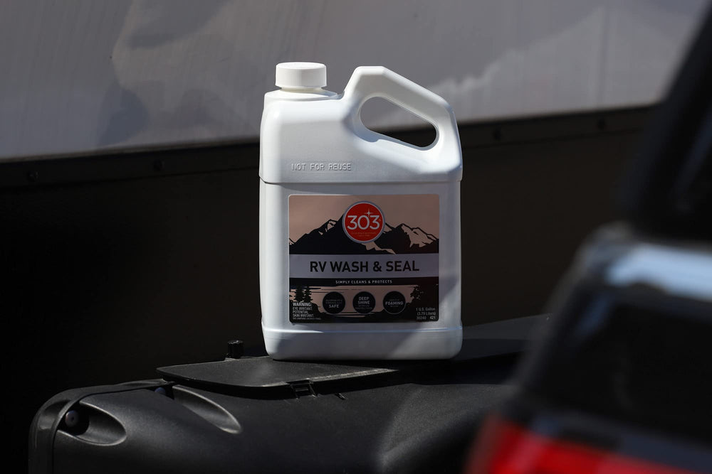 303 Products in campsite setting with RV to show travel-ready maintenance benefit