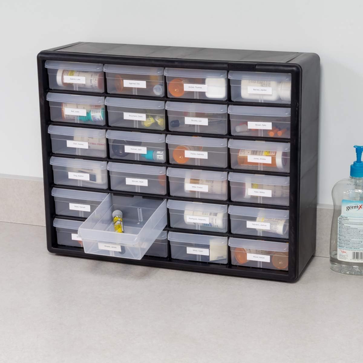 Akro-Mils cabinet beside a hand to show size and portable storage convenience