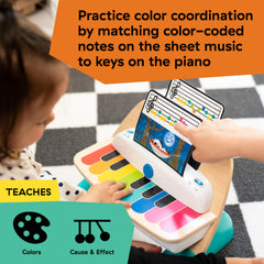 Baby Einstein piano with three color-coded music sheets for learning notes and coordination