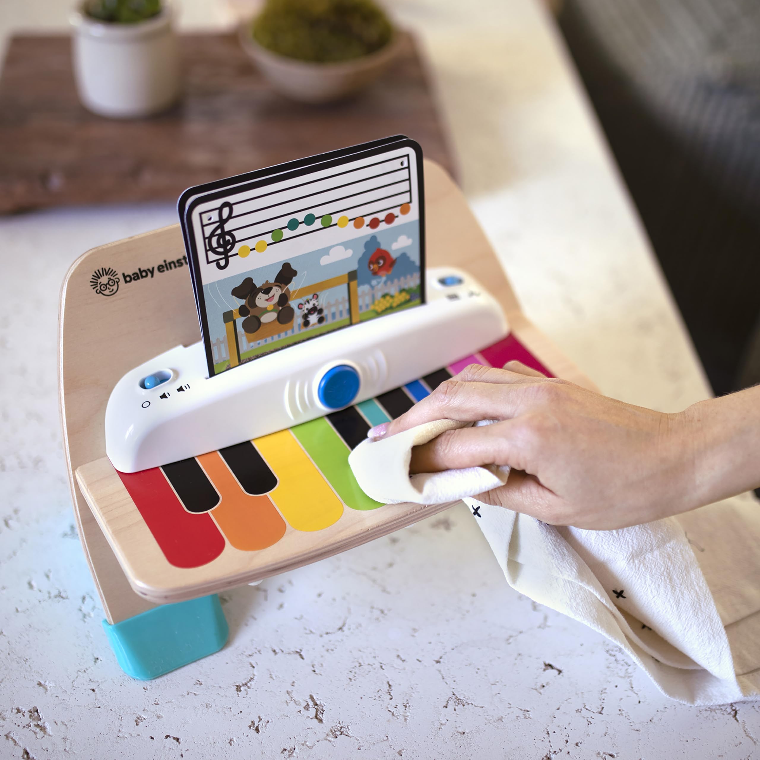 Baby Einstein piano boxed packaging and label highlighting included music sheets and specs