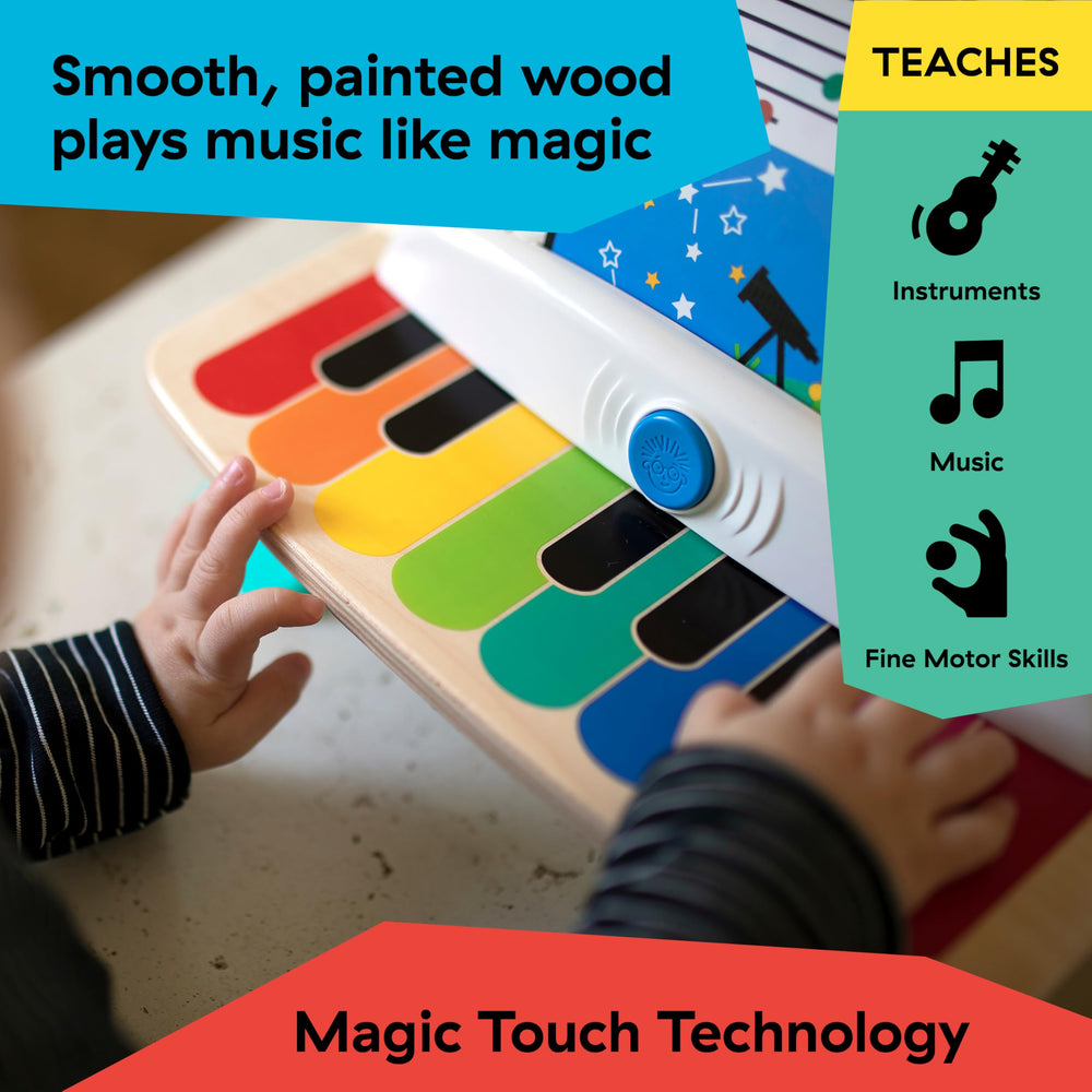 Baby Einstein piano beside an adult hand showing compact toddler-friendly size