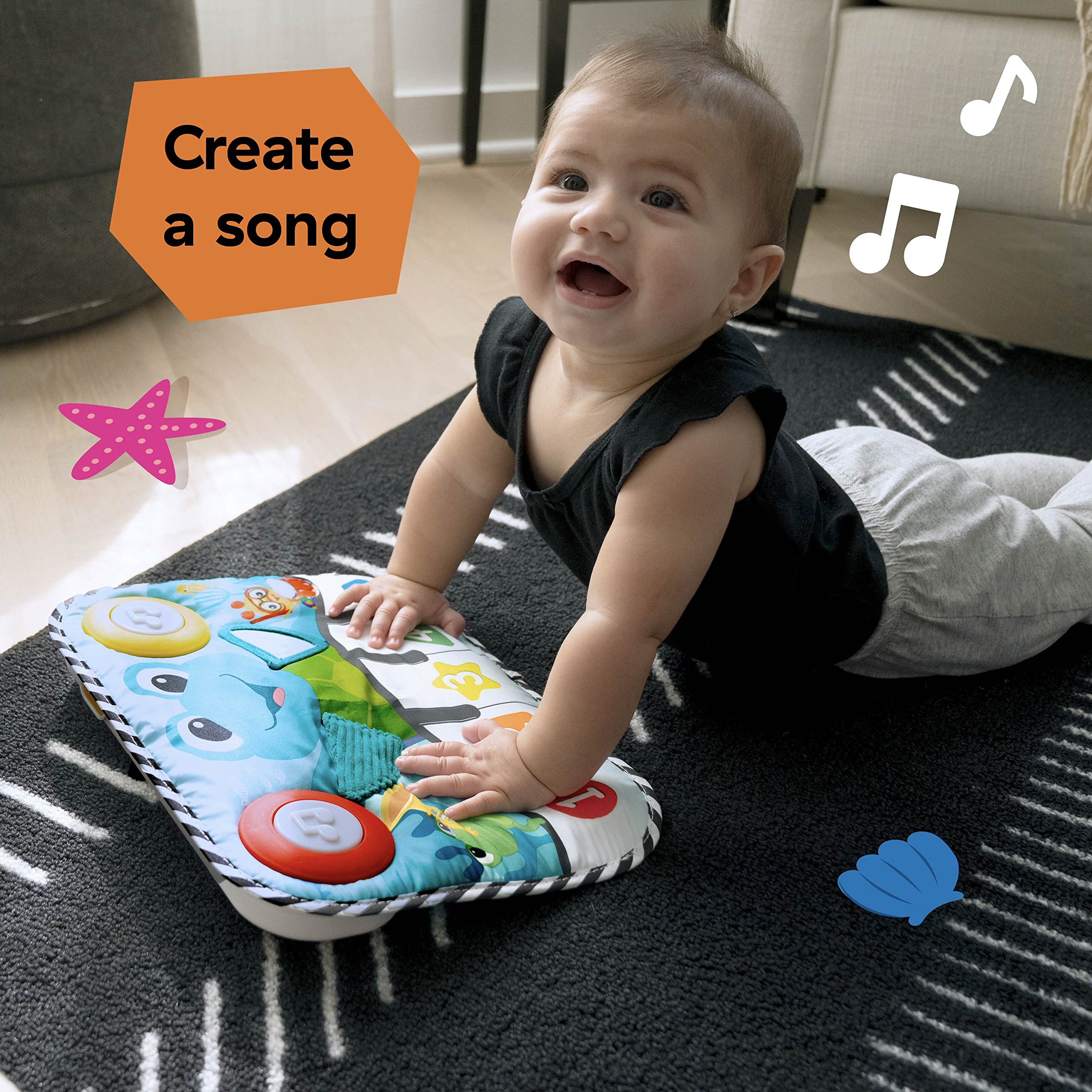 Baby Einstein pad beside crib rail showing compact scale and fit