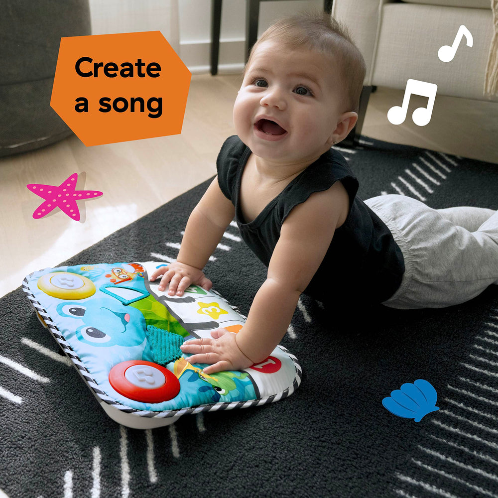 Baby Einstein pad beside crib rail showing compact scale and fit