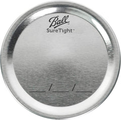Ball lids alongside empty mason jars illustrating ready-to-use convenience