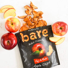 Bare apple chips held in hand demonstrating single-serve convenience benefit
