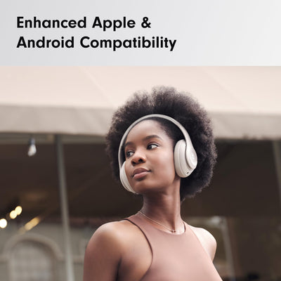 Person wearing Beats Studio Pro on a train illustrating noise isolation and commuting use