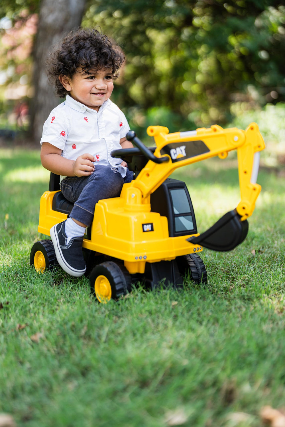 Best Ride On Cars CAT excavator in outdoor play setting boosting active imagination