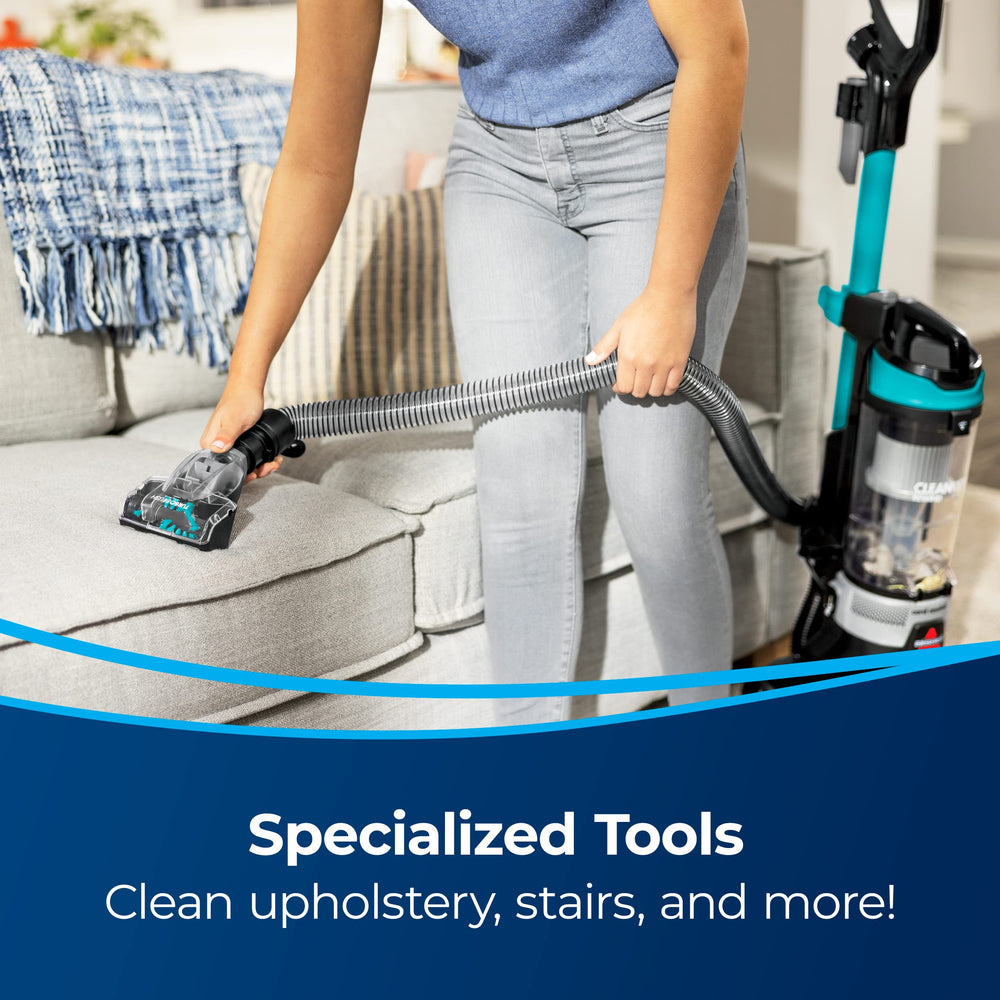 Bissell vacuum next to shoe for scale showing lightweight, easy-to-store size