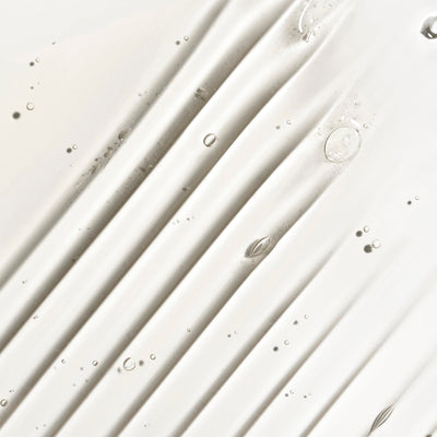 Model using Briogeo shampoo in shower showing scalp massage benefit