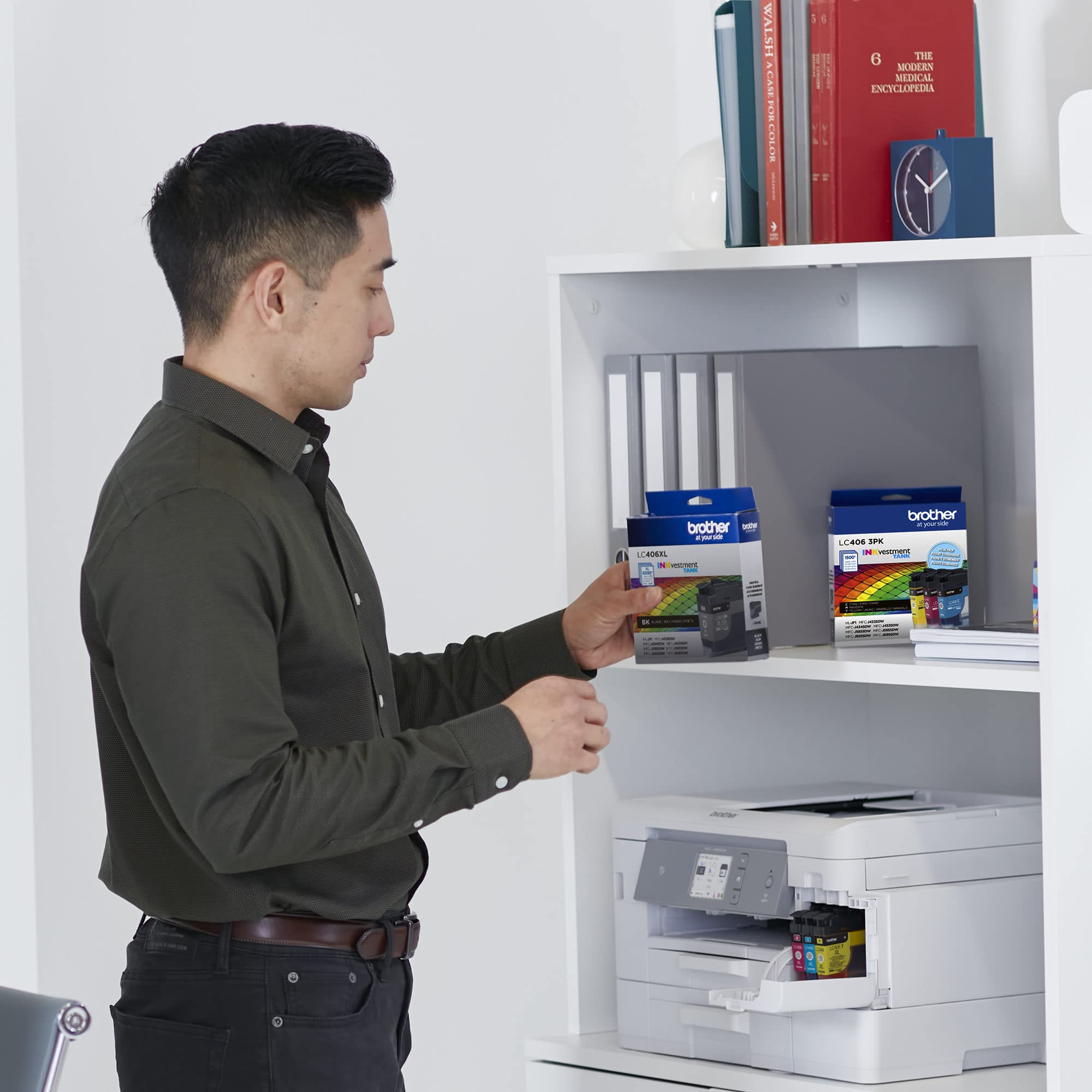Brother LC406 beside smartphone for size comparison and compact storage benefit