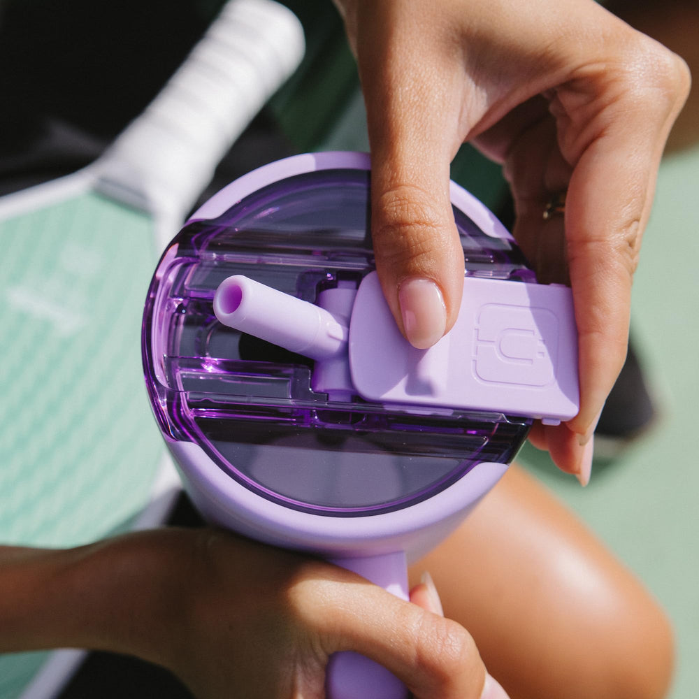 BrüMate Era Flip Java being used on a hike showing travel benefit: cup-holder friendly and portable