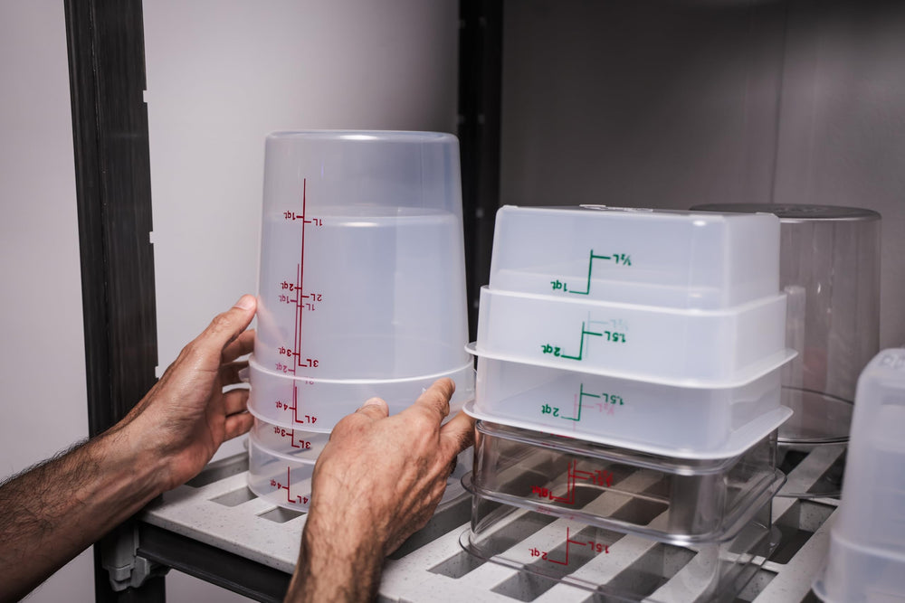 Cambro container held by hand showing 4 qt size and portioning convenience
