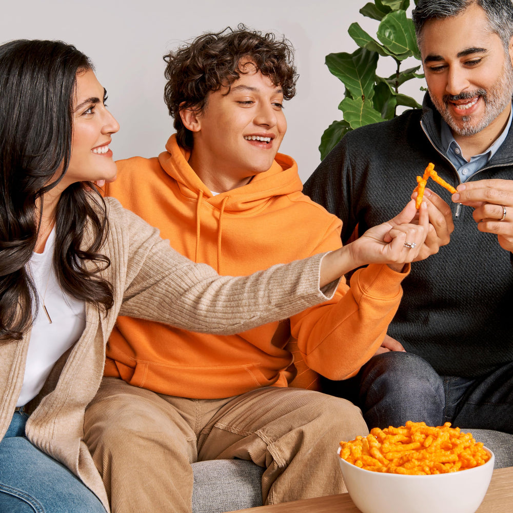 Cheetos bolsa en mano mostrando tamaño porción de 1 onza