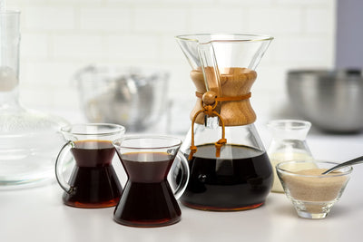 Chemex on kitchen counter styled with cups showing aesthetic appeal