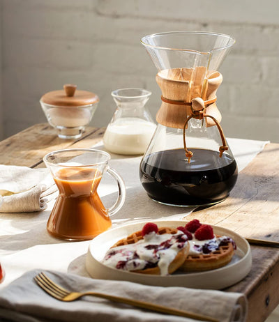 Chemex beside ceramic mug illustrating 8-cup capacity and serving scale