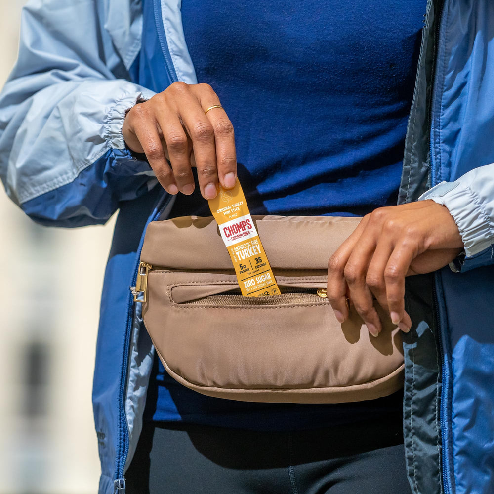 Chomps sticks packed in backpack illustrating durable snack for outdoor activity