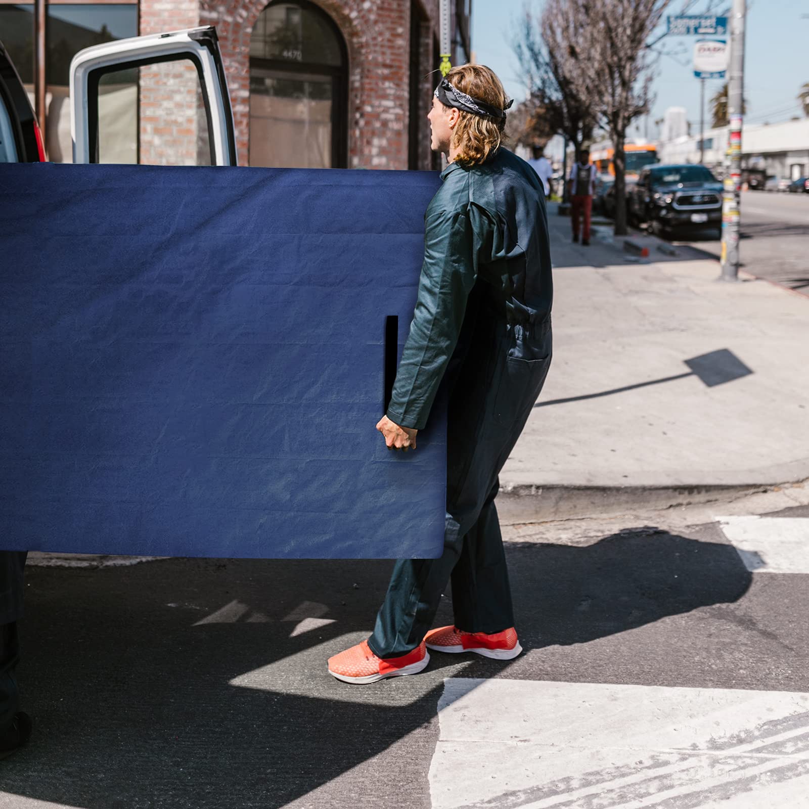 Coldwind lifestyle photo of two people carrying mattress in bag for safe move