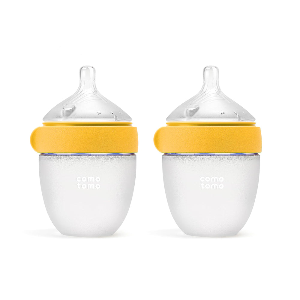 Comotomo botella frontal amarilla mostrando diseño y doble pack beneficios