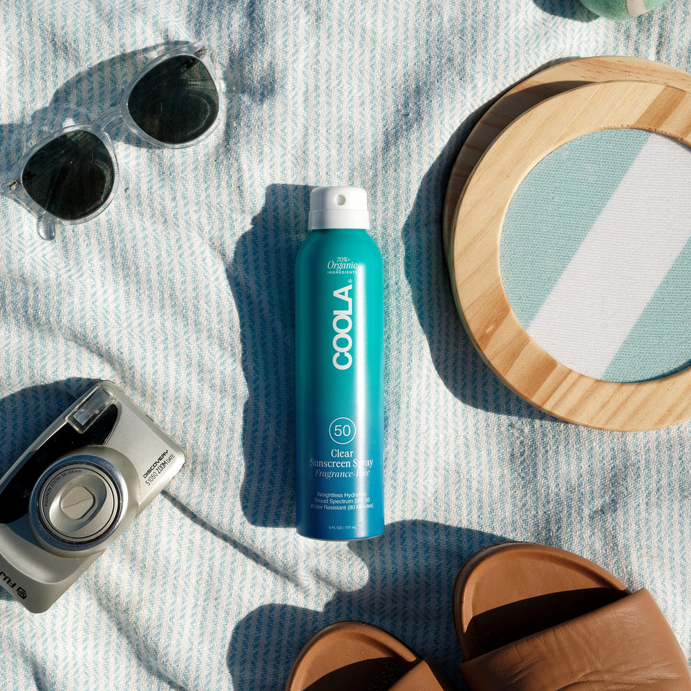 COOLA mist texture in air showing clear finish and quick absorption benefit