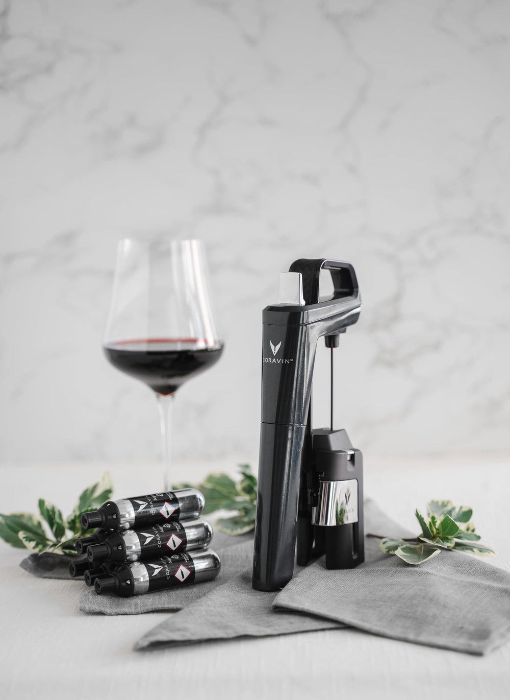 Coravin in-use pouring wine with capsule connected for preserved glasses