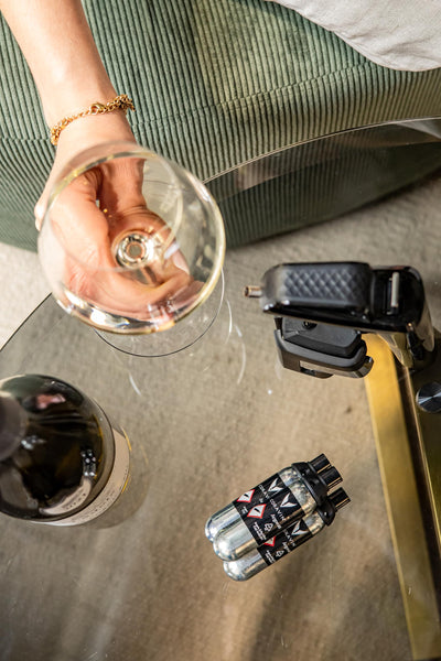 Coravin capsules beside coin for size comparison and easy storage