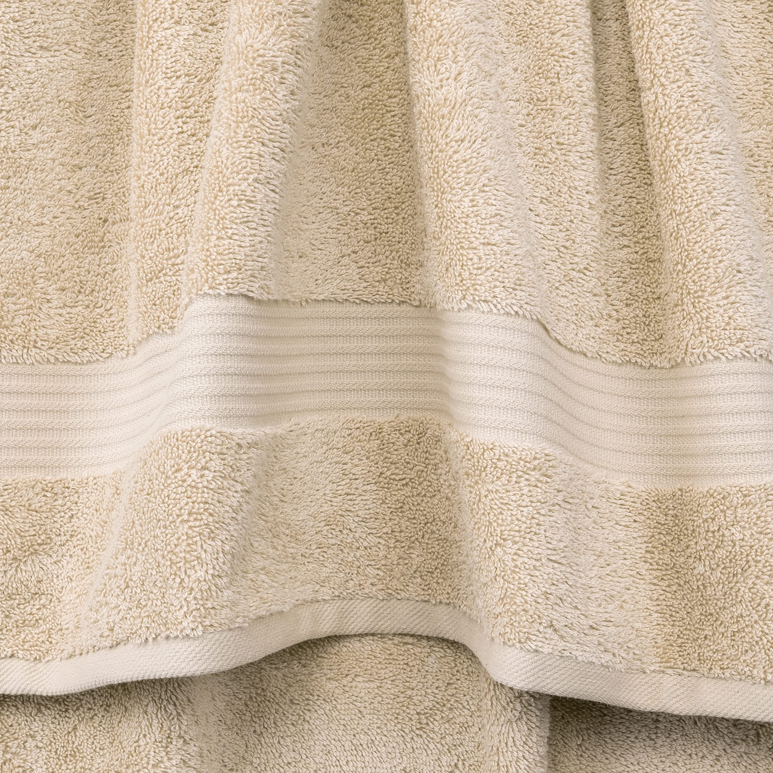 Cotton Paradise folded bath towel stack illustrating plush thickness and spa look