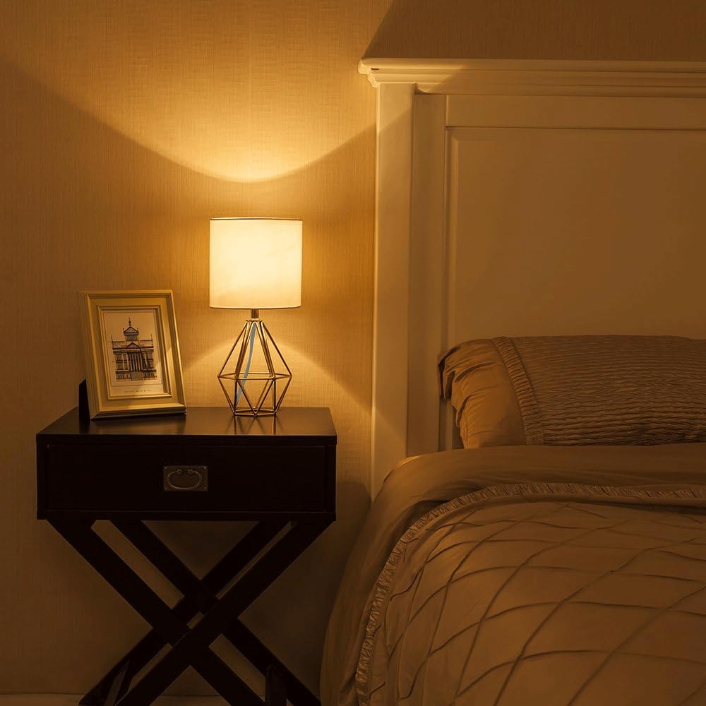 COTULIN gold lamp next to a book showing scale and small footprint