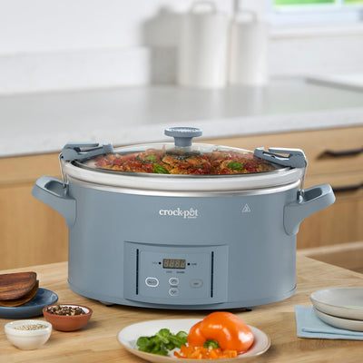 Crock‑Pot large handles being lifted showing easy, secure carrying and transport