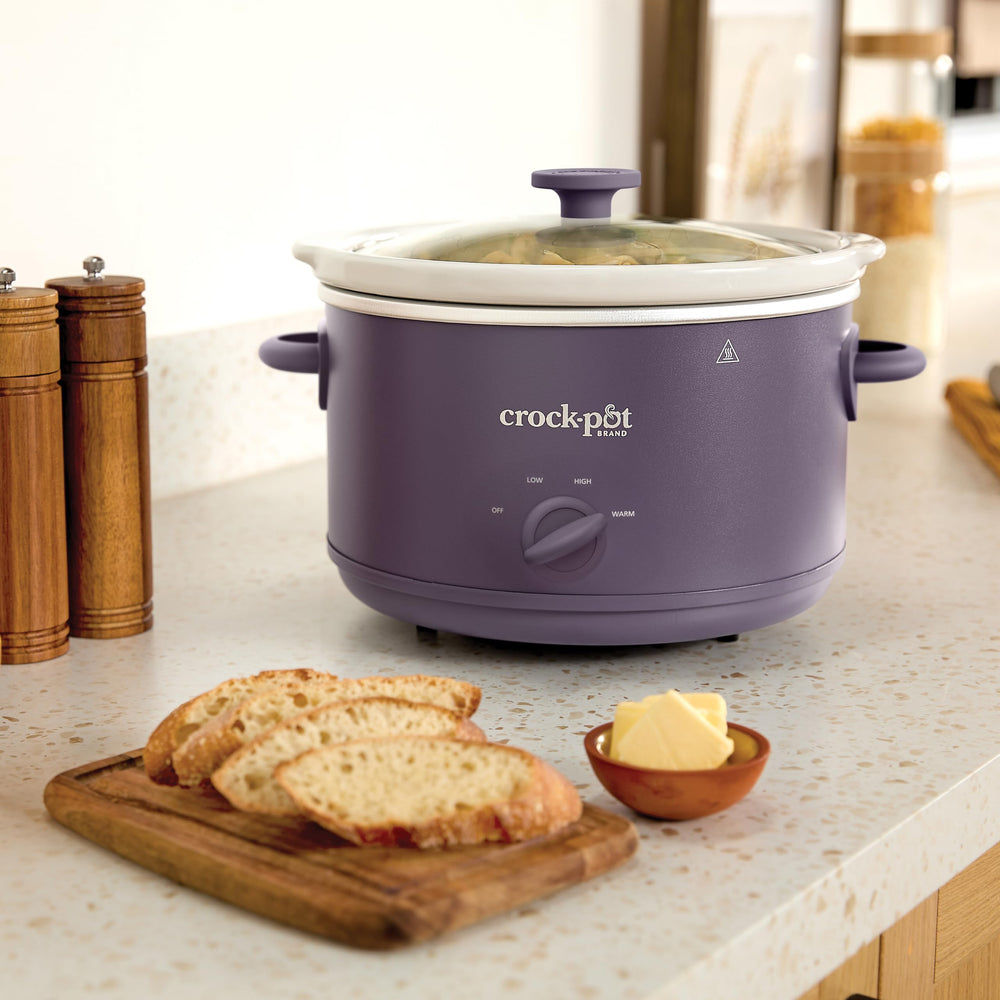 Crock-Pot box and pamphlet showing included one-year warranty benefit