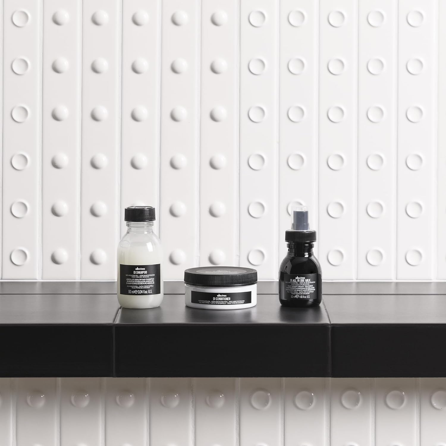 Davines OI milk in toiletry bag for travel convenience and lightweight hydration