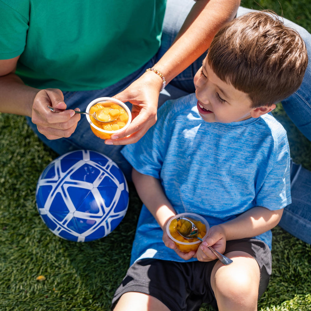 Dole persona comiendo mango de vaso, snack práctico fuera de casa