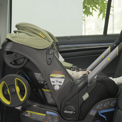 DOONA belt-locking clip close-up highlighting secure seat belt installation benefit