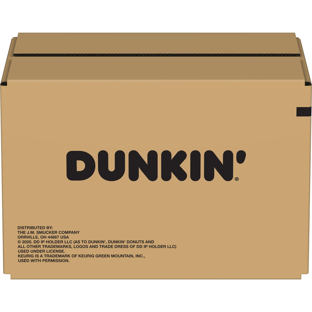 Dunkin' cup on kitchen counter with box nearby showing everyday convenience