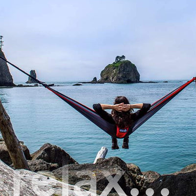 ENO Atlas lifestyle scene with person relaxing in a hammock to show comfort and outdoor enjoyment