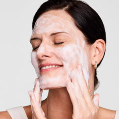 Estée Lauder in-use during face washing, demonstrates effective makeup removal benefit