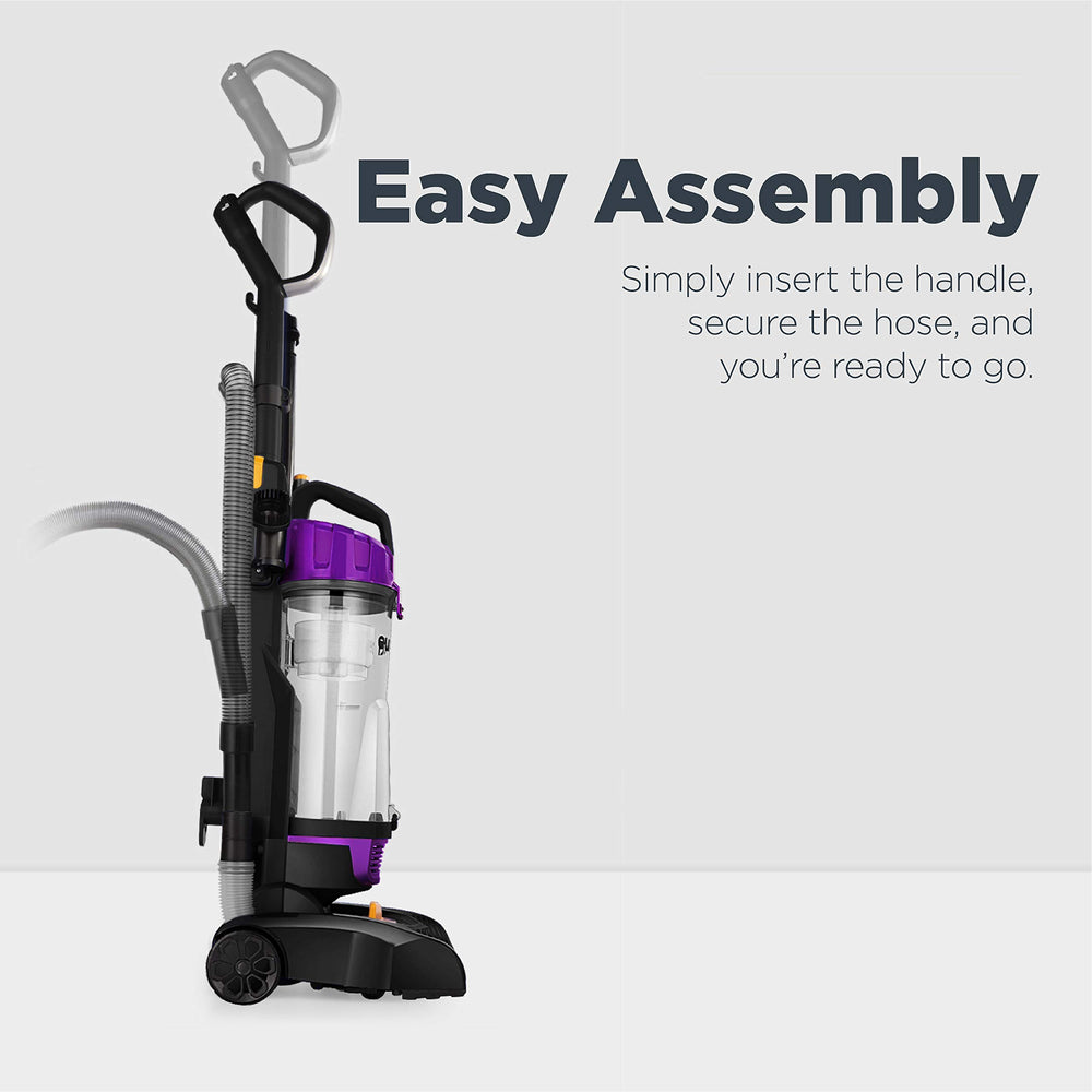 Eureka vacuum next to chair showing compact size and easy portability