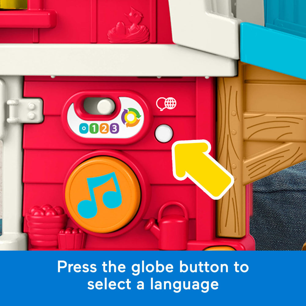 Fisher-Price niño pequeño usando la granja activando música para estimular juego y lenguaje